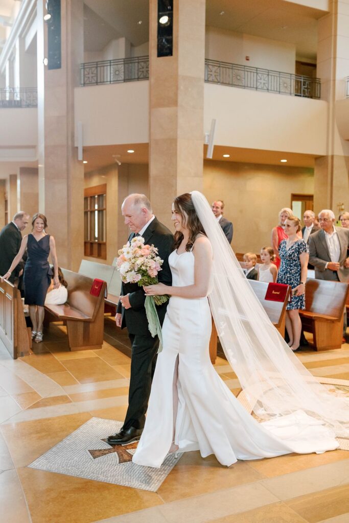 The father of the bride walking bride down the aisle